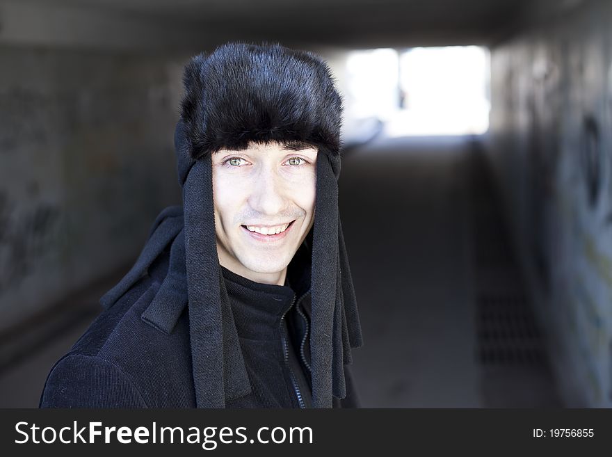Smiling young man in subway tunnel