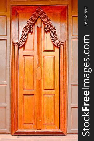 Thai style wooden temple door on brown door. Thai style wooden temple door on brown door