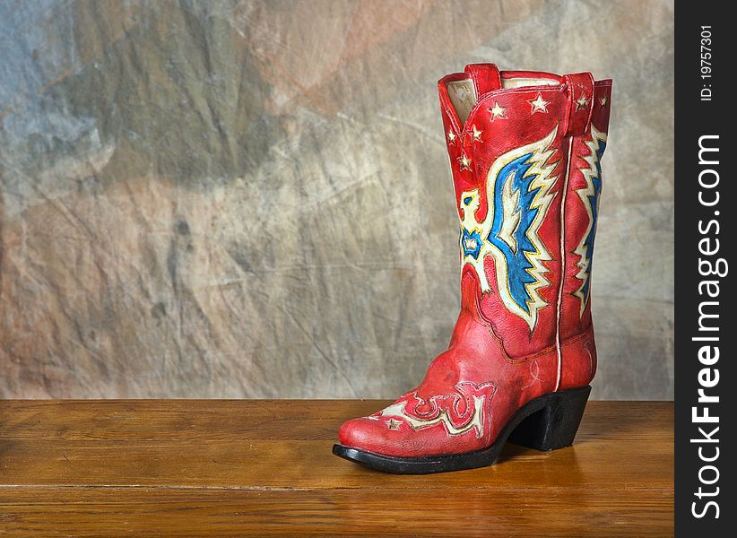 Red vintage cowboy boot on wood set
