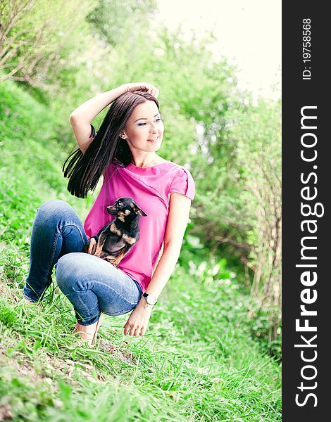 Beautiful Girl With A Puppy In The Garden