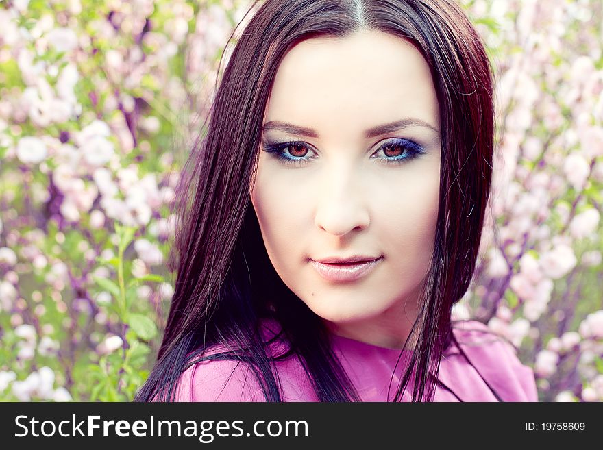 Portrait of a girl in a flowered garden