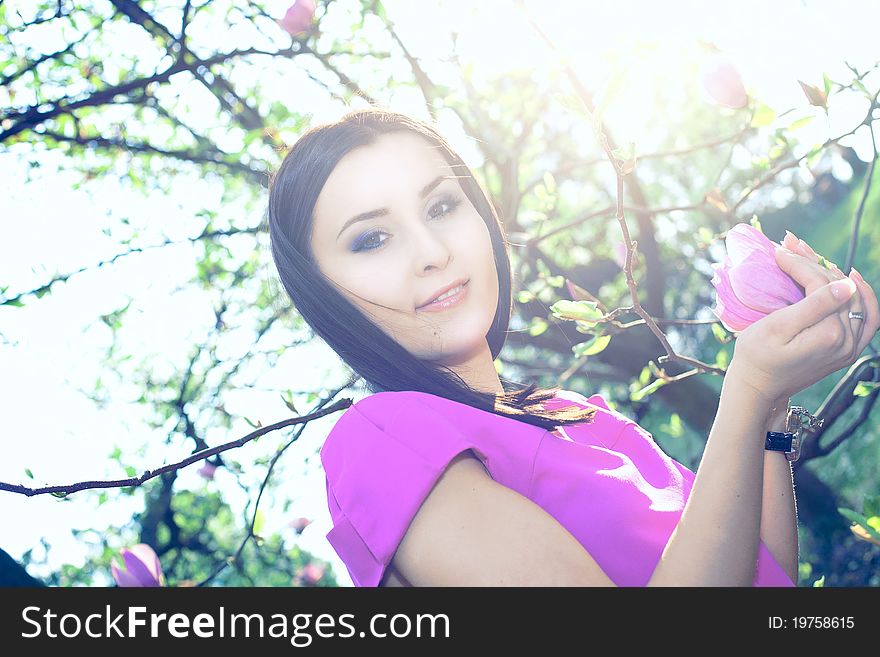 Beautiful healthy young Woman with spring flowers