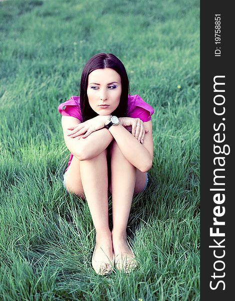 Pretty young woman outdoor in the grass