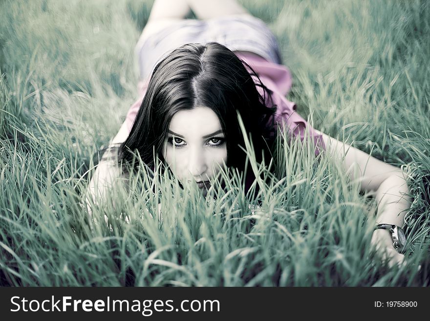 Beautiful Girl Lying On The Grass