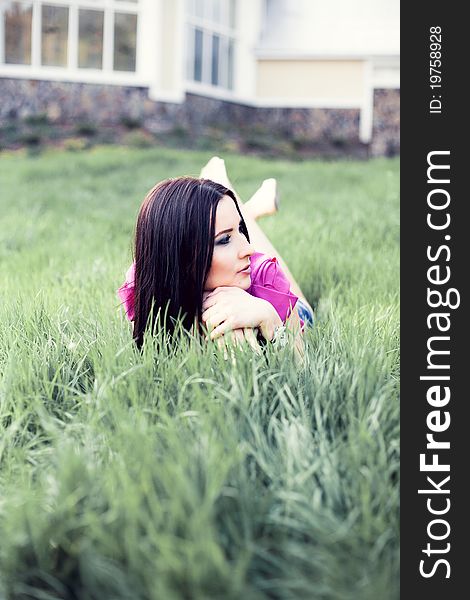 Woman laying on green grass. Woman laying on green grass