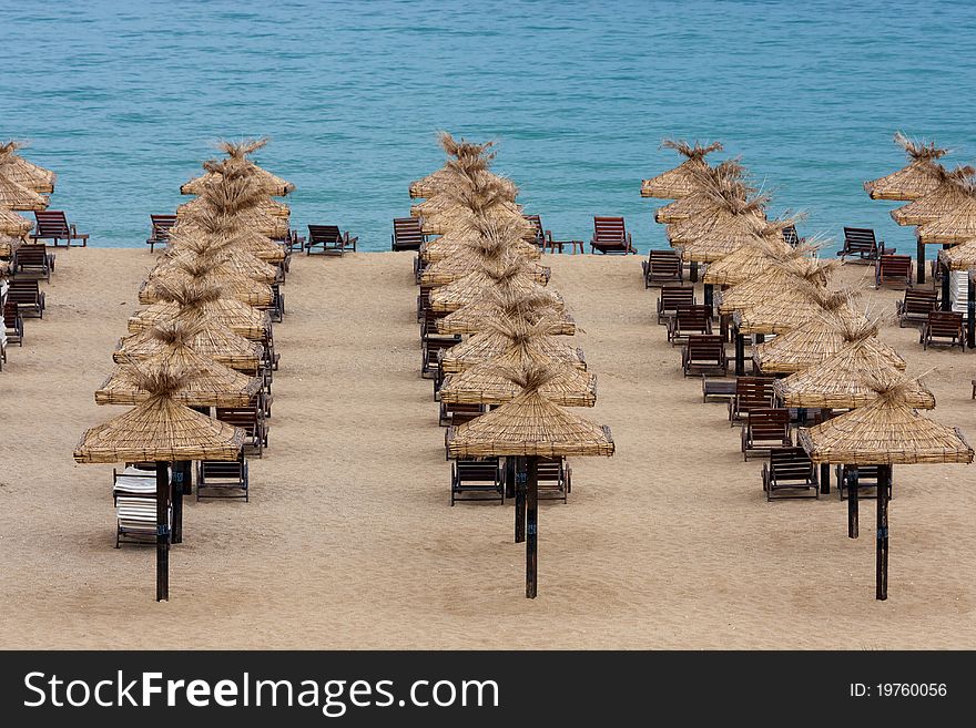 Empty beach with chairs and umbrellas in the morning