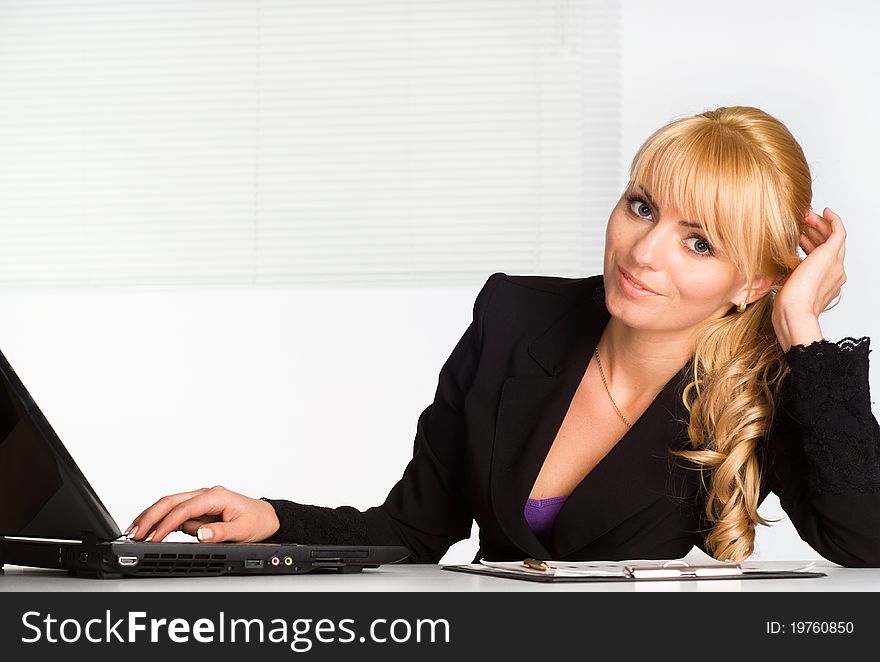 Very cute girl working with laptop at table. Very cute girl working with laptop at table