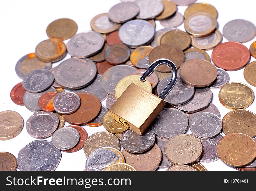 An open lock sitting on some scattered coins. An open lock sitting on some scattered coins