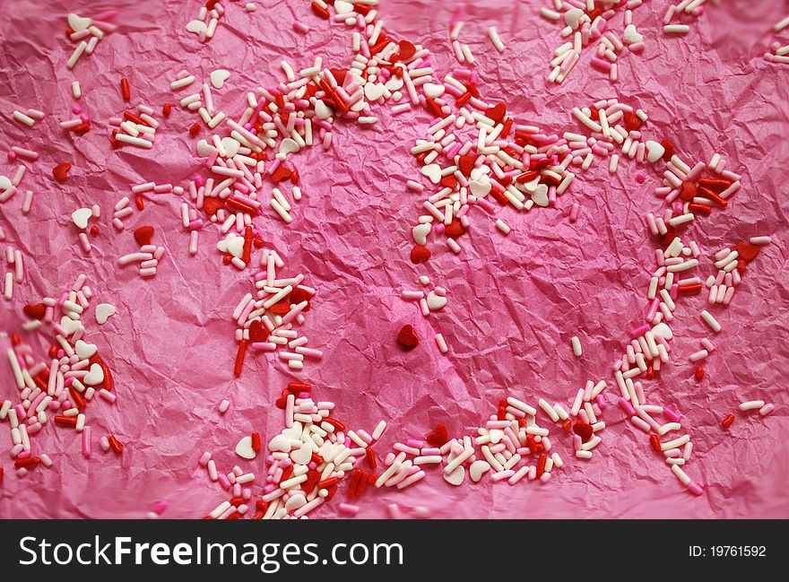 Pink tissue paper with red and white candy/hearst. Pink tissue paper with red and white candy/hearst
