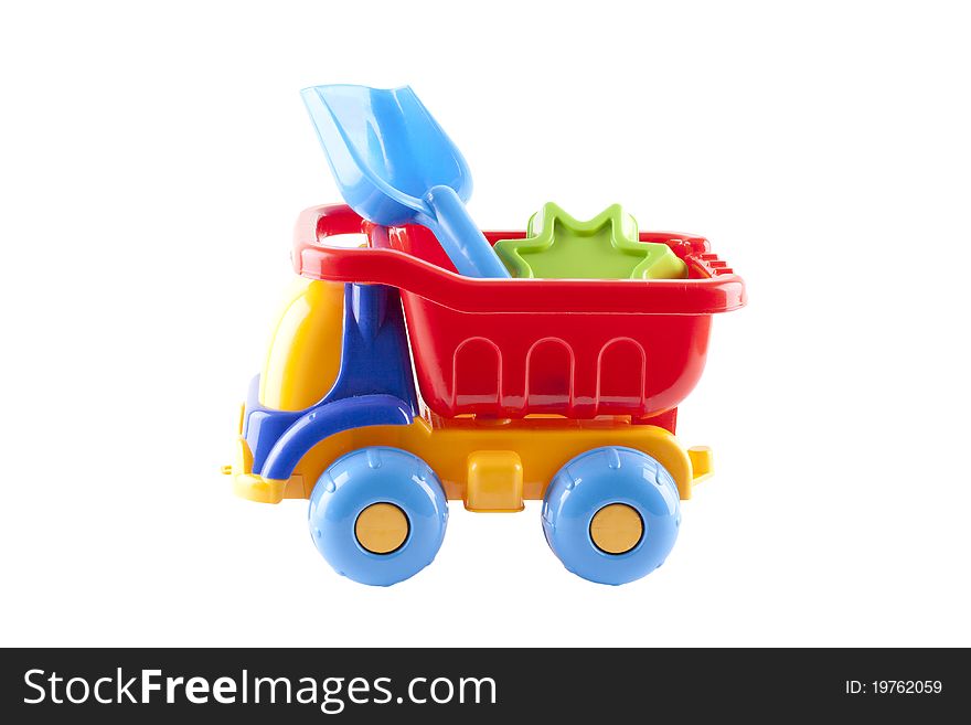 Big Colorful Toy Truck on a white background with children with shovels. Big Colorful Toy Truck on a white background with children with shovels