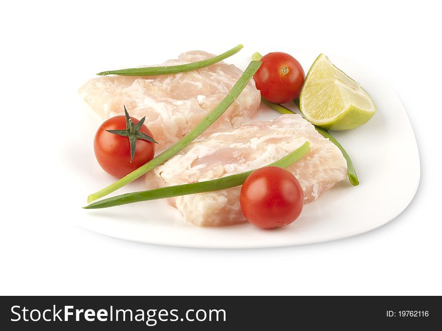 Pangasius fillet molded, decorated with cherry tomatoes and lime green onions