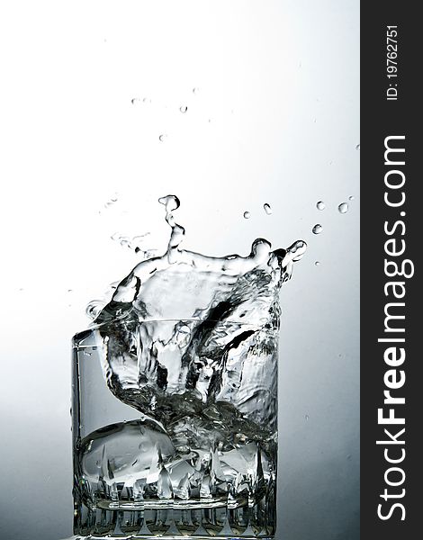 Water splash on glass over the graduated background