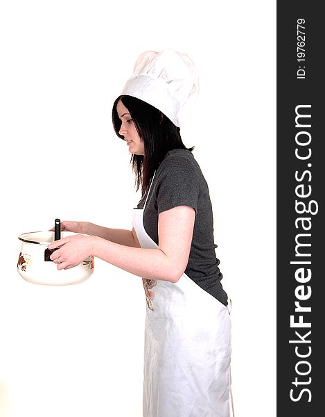 A pretty young woman, holding a cook pot, standing with an apron, black hair and a cook hat for white background. A pretty young woman, holding a cook pot, standing with an apron, black hair and a cook hat for white background.