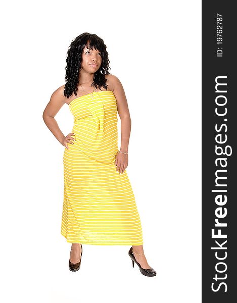 A beautiful African-American woman in a long yellow dress and dark
black hair standing in the studio, for white background. A beautiful African-American woman in a long yellow dress and dark
black hair standing in the studio, for white background.