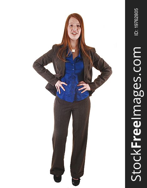 A red haired young businesswoman standing in the studio in a brown suit and blue blouse, for white background. A red haired young businesswoman standing in the studio in a brown suit and blue blouse, for white background.