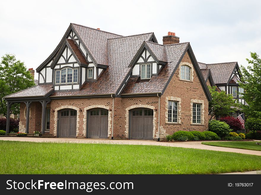 Image of a single family home with many windows and beautiful landscaping. Image of a single family home with many windows and beautiful landscaping.