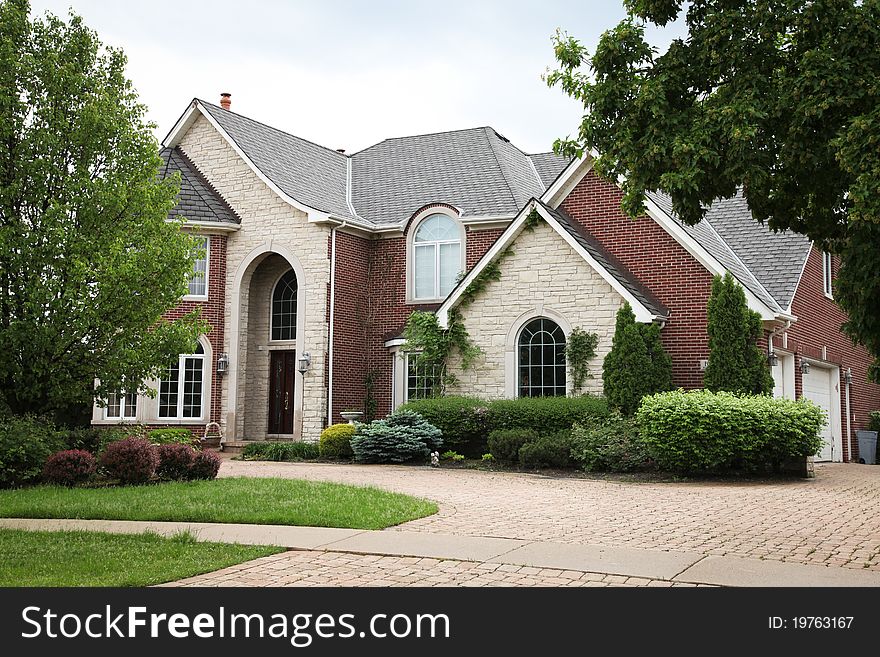 Image of a single family home with many windows and beautiful landscaping. Image of a single family home with many windows and beautiful landscaping.