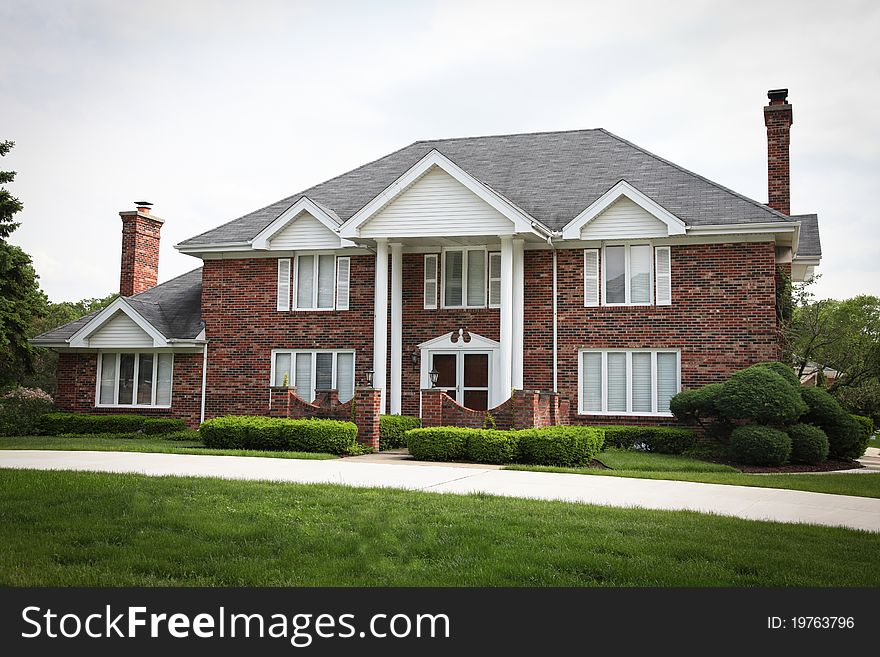 Image of a single family home with many windows and beautiful landscaping. Image of a single family home with many windows and beautiful landscaping.