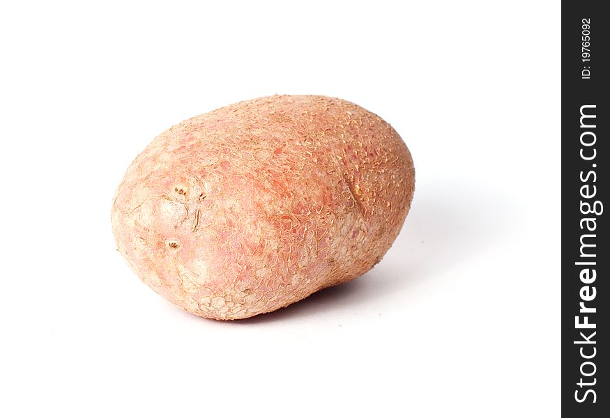 Single red potato closeup isolated on white background