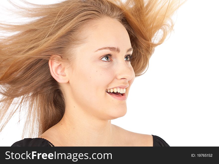 Joyful young woman with waving hair smiling happily