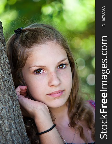 Portrait of a teen girl near the tree. Portrait of a teen girl near the tree.