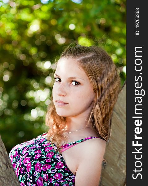 Portrait of a teen girl near the tree. Portrait of a teen girl near the tree.