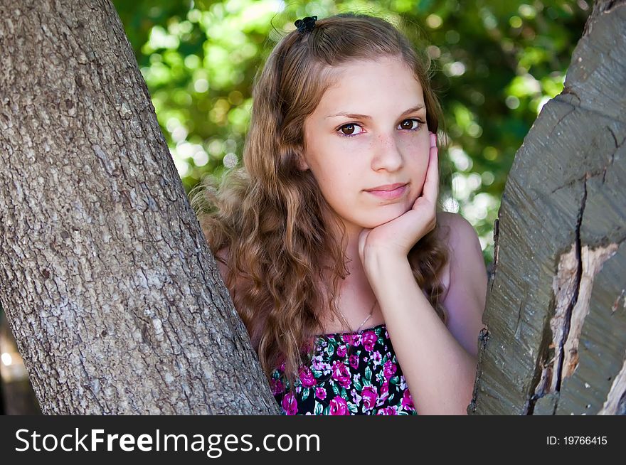 Portrait of a teen girl near the tree. Portrait of a teen girl near the tree.