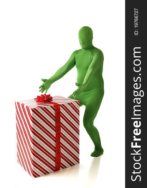 A green morphed man displaying his big red and white wrapped Christmas gift.  Isolated on white. A green morphed man displaying his big red and white wrapped Christmas gift.  Isolated on white.