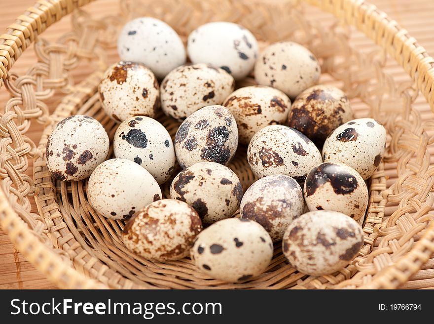 Closeup of quail eggs in a basket