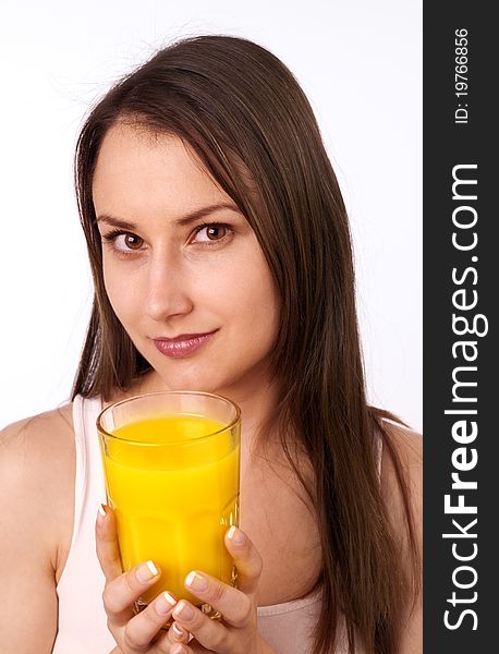 Attractive young woman holding a glass of orange juice. Attractive young woman holding a glass of orange juice