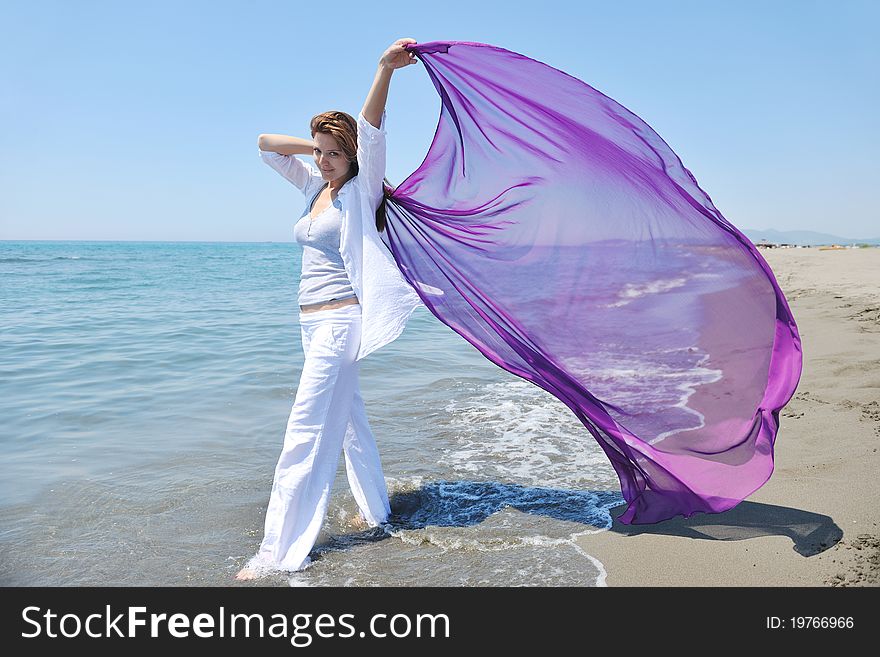 Beautiful young woman on beach with scarf relax smile and have fun