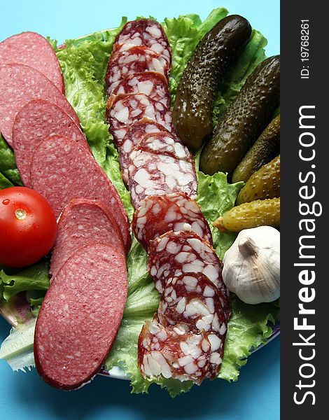 Plate with vegetables and sausage cutting. Plate with vegetables and sausage cutting