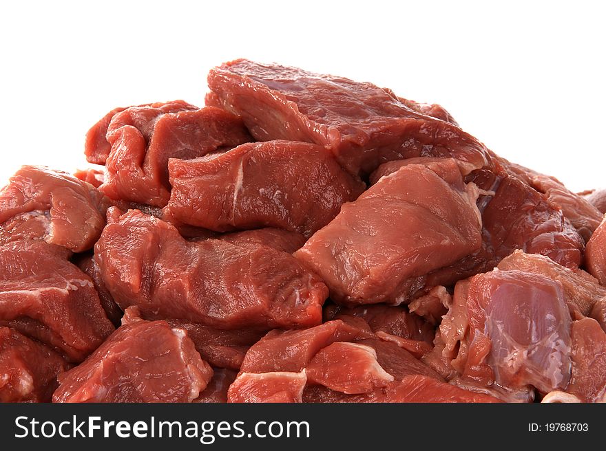 Pieces of raw meat on a white background