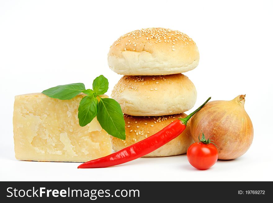 An image of buns, cheese, onion, pepper and tomato. An image of buns, cheese, onion, pepper and tomato