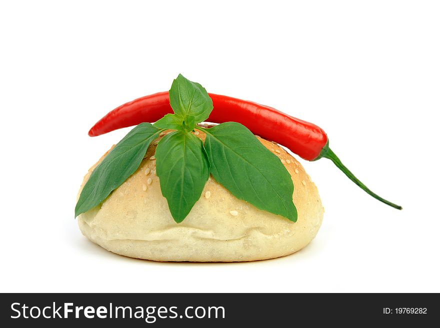 An image of a fresh bun, pepper and basil. An image of a fresh bun, pepper and basil