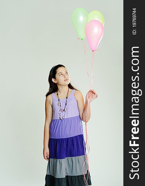 An image of a young girl with three balloons