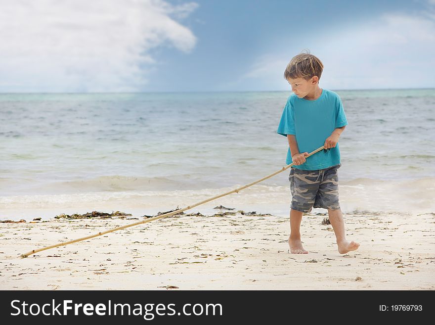 Young boy playing on sand beach. Young boy playing on sand beach