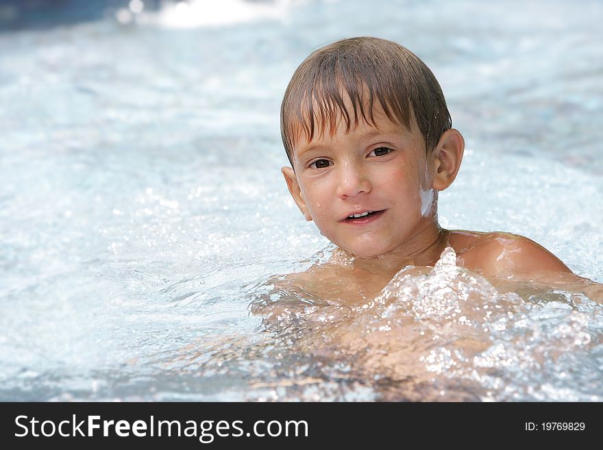 Portrait of young boy swimming in pool