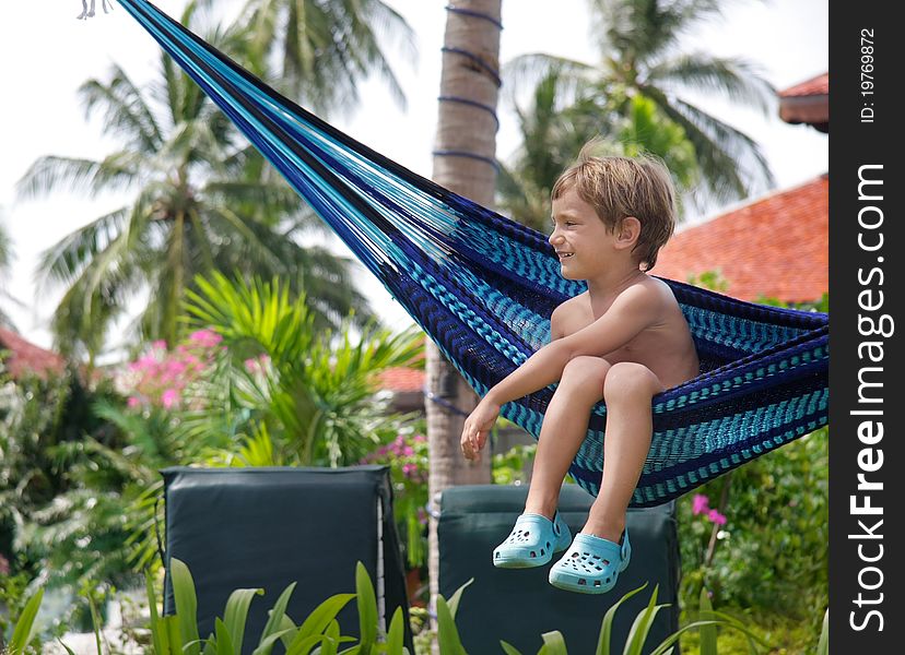 Young boy relaxing in hammock. Young boy relaxing in hammock