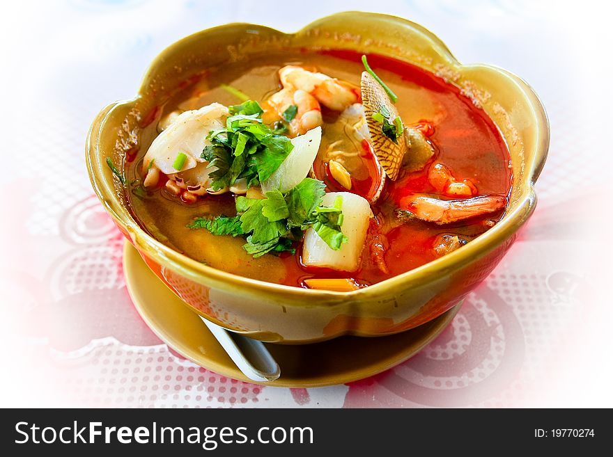 Sharp and hot Thai soup with seafood