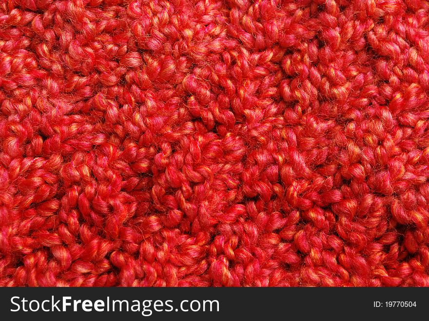 Knitted red orange yarn background. Knitted red orange yarn background