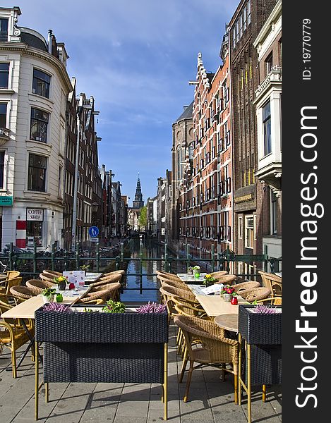 Outdoor terrace restaurant on the canal in Amsterdam. Urban scene