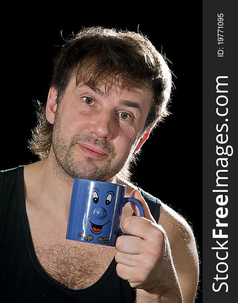 The man with a dark blue mug on a black background