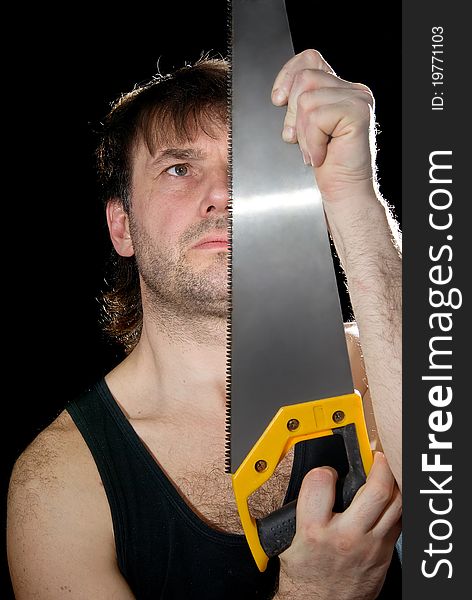 The man with the tool on a black background