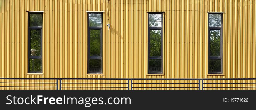 Yellow wall with windows and videocamera