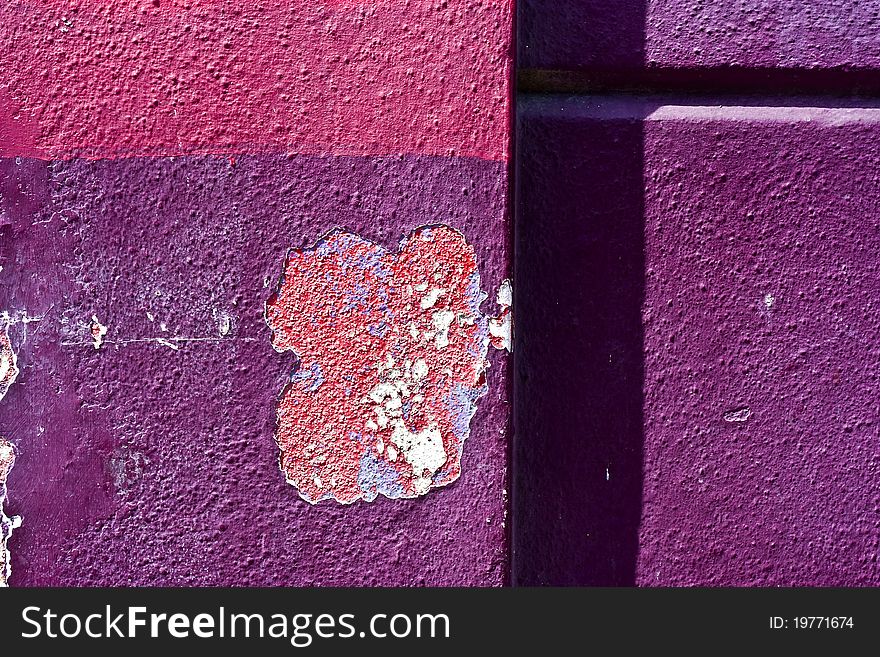 A concrete wall with shadows and peeling paint. A concrete wall with shadows and peeling paint