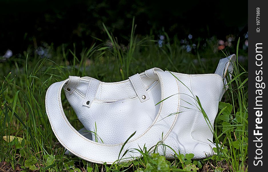 A white bag in grass. A white bag in grass