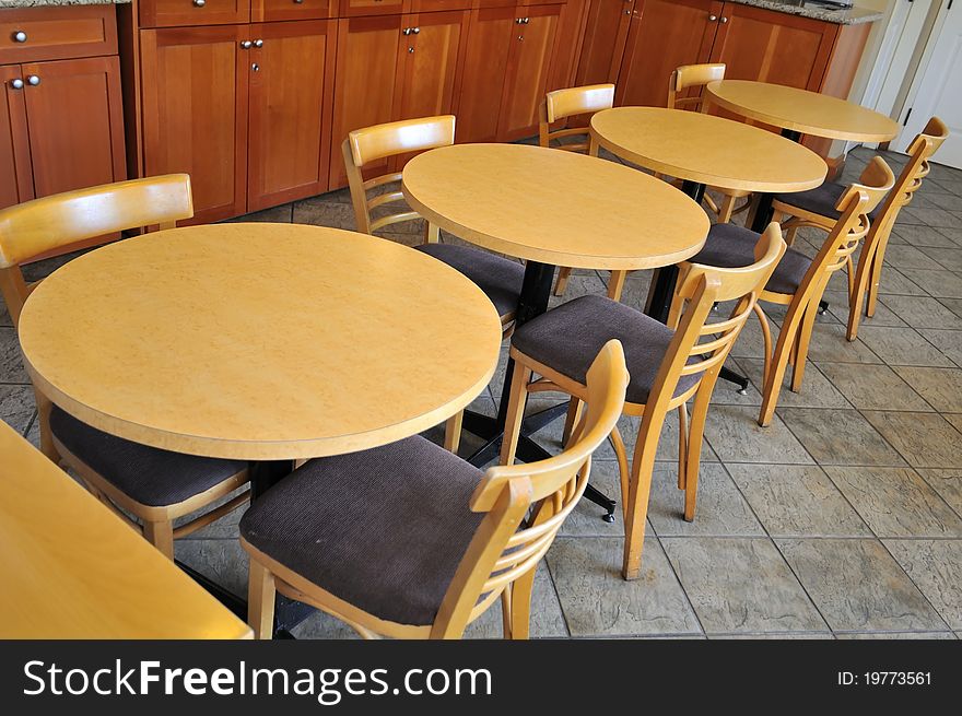 Clean tables lined up neatly in dining area.