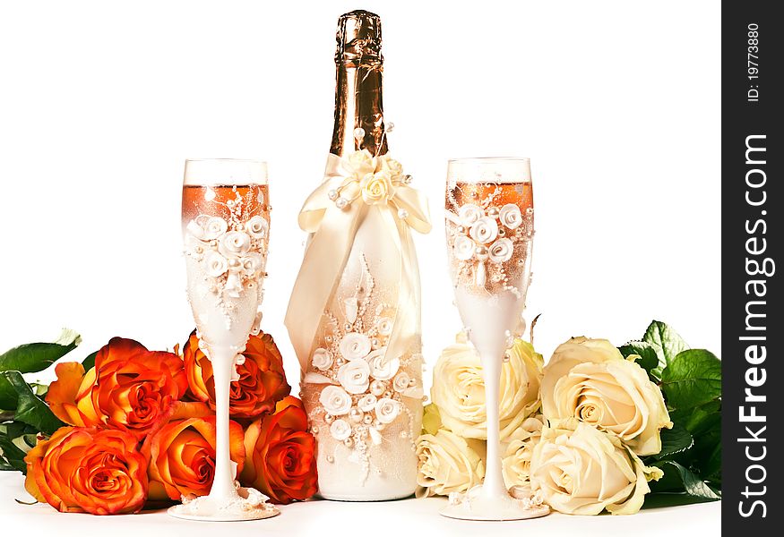 Two glasses of celebratory champagne with white roses. Two glasses of celebratory champagne with white roses