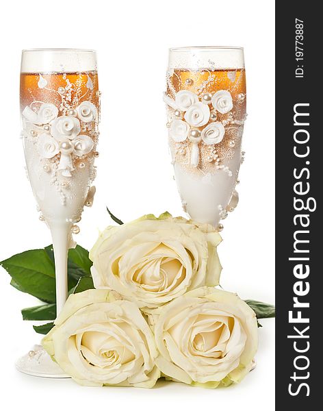 Two glasses of celebratory champagne with white roses. Two glasses of celebratory champagne with white roses